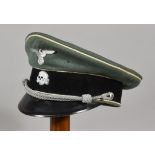 A German WWII Cap, field grey with eagle over swastika badge and deathshead badge