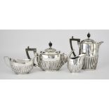 An Edward VII Harlequin Silver Oval Four-Piece Tea Service by William Hutton & Sons, London &