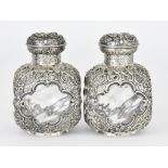 A Pair of Late Victorian Silver Mounted and Glass Square Scent Bottles the mounts by William Comyns,