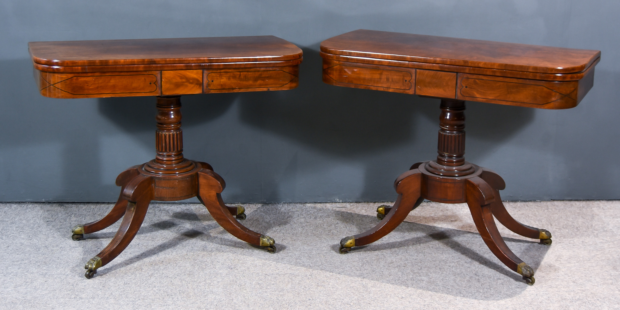 A Pair of William IV Mahogany Rectangular Card Tables, the baize-lined folding tops with rounded