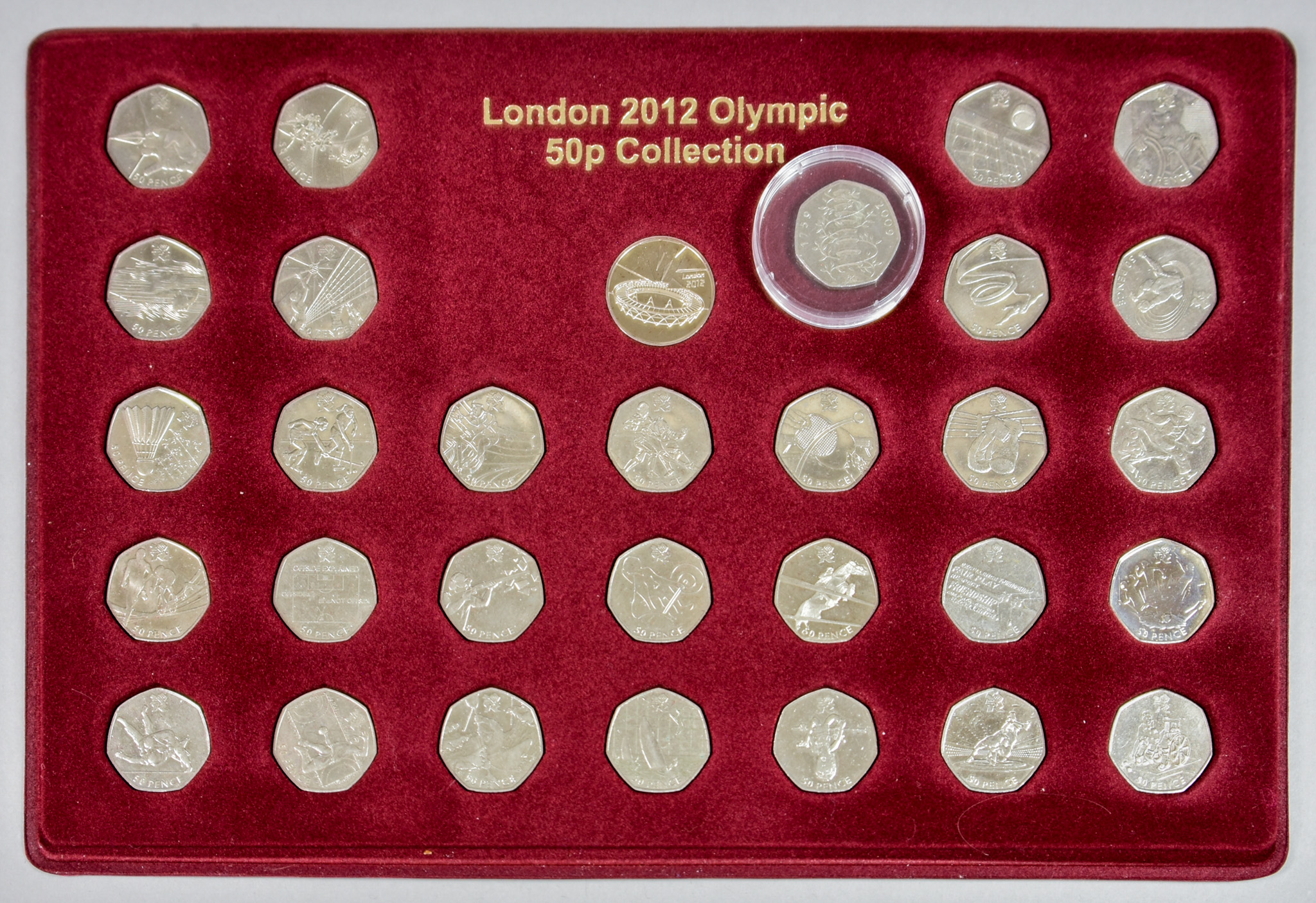 A 2009 Kew Gardens Fifty Pence Piece, a London 2012 Olympic fifty pence piece collection in fitted