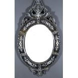 A Late 19th/Early 20th Century Venetian Oval Wall Mirror, with scroll cresting and apron, mirrored