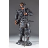 A Japanese Bronzed Metal Standing Figure of a Samurai Warrior, holding a staff with a bird perched