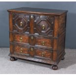An Early 18th Century Panelled Oak Chest, with moulded edge to top, fitted three long drawers with