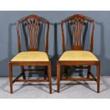A Pair of 18th Century Mahogany Dining Chairs of "Hepplewhite" Design, the shield backs with fretted