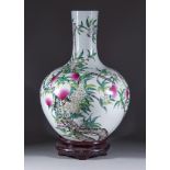 A Chinese Famille Rose Porcelain Bottle Vase, 20th Century, decorated with nine peaches amongst