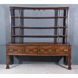 An 18th Century Oak Dresser, the upper part with moulded cornice, fitted three open shelves with