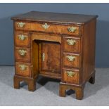 A George II Figured Walnut Kneehole Dressing Table, the quarter veneered top and drawer fronts