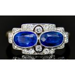 An 18ct Gold Sapphire and Diamond Ring, Early 20th Century, set with two centre sapphire stones