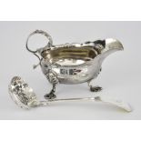 A Late George III Silver Oval Sauce-Boat and a William IV Sugar Sifter Spoon, the sauce-boat by