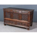 An 18th Century Continental Oak Mule Chest, with plain two plank lid, carved frieze, triple panelled