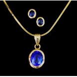 An 18ct Gold Sapphire Suspended Pendant and Earrings, Modern, the pendant collet set with a