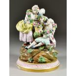 A Porcelain Group of Three Figures, Late 19th/Early 20th Century, on a rocky outcrop, a lady