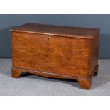 A 19th Century Elm Coffer, plain lid with moulded edge, on shaped apron and bracket feet, 35ins wide