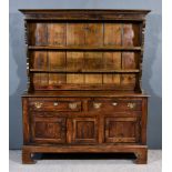 An 18th Century Oak Dresser, the upper part with moulded cornice, fitted two shelves, the base