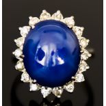 A Cabochon Star Sapphire and Diamond Ring, 20th Century, set with a centre cabochon star sapphire,