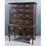 An Old Panelled Oak Chest on Stand, the whole carved with leaf scroll ornament and "AM 1662", the