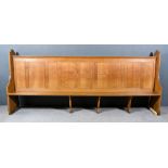 A Large Victorian Oak Pew, with heavy shaped and moulded end supports, panelled back and plain