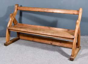 A Late 19th/Early 20th Century Pine Bench, with plain crest rail and seat, on shaped end supports,