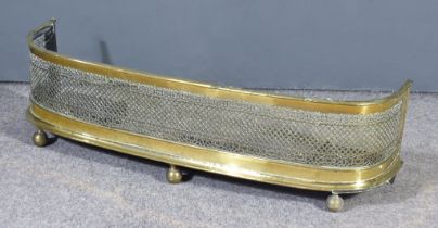 An English Pierced Brass and Steel Fire Fender, 19th Century, on three ball feet, 40ins wide x 11.