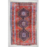 An Early 20th Century Kazak Carpet, woven in colours of navy blue, pale blue and wine, three