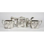 A Chinese Silver Three-Piece Tea Service, by Luen Wo of Shanghai, the shaped bodies with applied