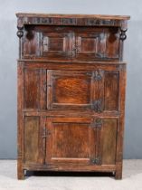 An Early 18th Century Panelled Oak Court Cupboard, the upper part with frieze carved "IMAI 1712",
