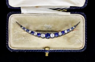 A Blue and White Sapphire Crescent Brooch, Early 20th Century, set with blue and white faceted