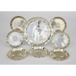 A George V Silver Circular Dish and Seven Similar Coasters, the larger dish by William Comyns,