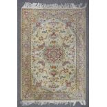 A 20th Century Tabriz Rug, woven in pastel shades, the bold central stylised floral medallion