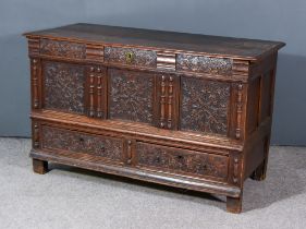 An 18th Century Continental Oak Mule Chest, with plain two plank lid, carved frieze, triple panelled