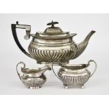 A Late Victorian Silver Rectangular Teapot, a Jug and an Edwardian Sugar Basin, all with gadroon