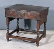 An Old Oak Bible Box, with moulded edge to lifting top, on bobbin turned supports, with plain H-
