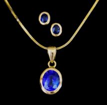 An 18ct Gold Sapphire Suspended Pendant and Earrings, Modern, the pendant collet set with a