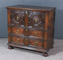 An Early 18th Century Panelled Oak Chest, with moulded edge to top, fitted three long drawers with