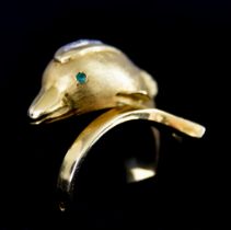 An 18ct Gold Ring, Modern, in the form of a dolphin, set with small white and green stones, size