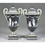 A Pair of Wedgwood Black and White Basalt Two-Handled Urns and Covers, 19th Century, the centres