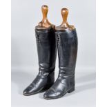 A Pair of Black Leather Riding Boots, with a pair of wooden boot trees