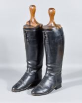 A Pair of Black Leather Riding Boots, with a pair of wooden boot trees