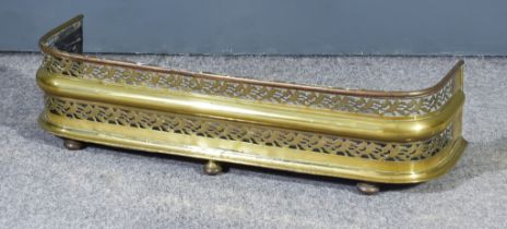 An English Pierced Brass and Steel Fire Fender, 19th Century, the piercing restricted to an upper