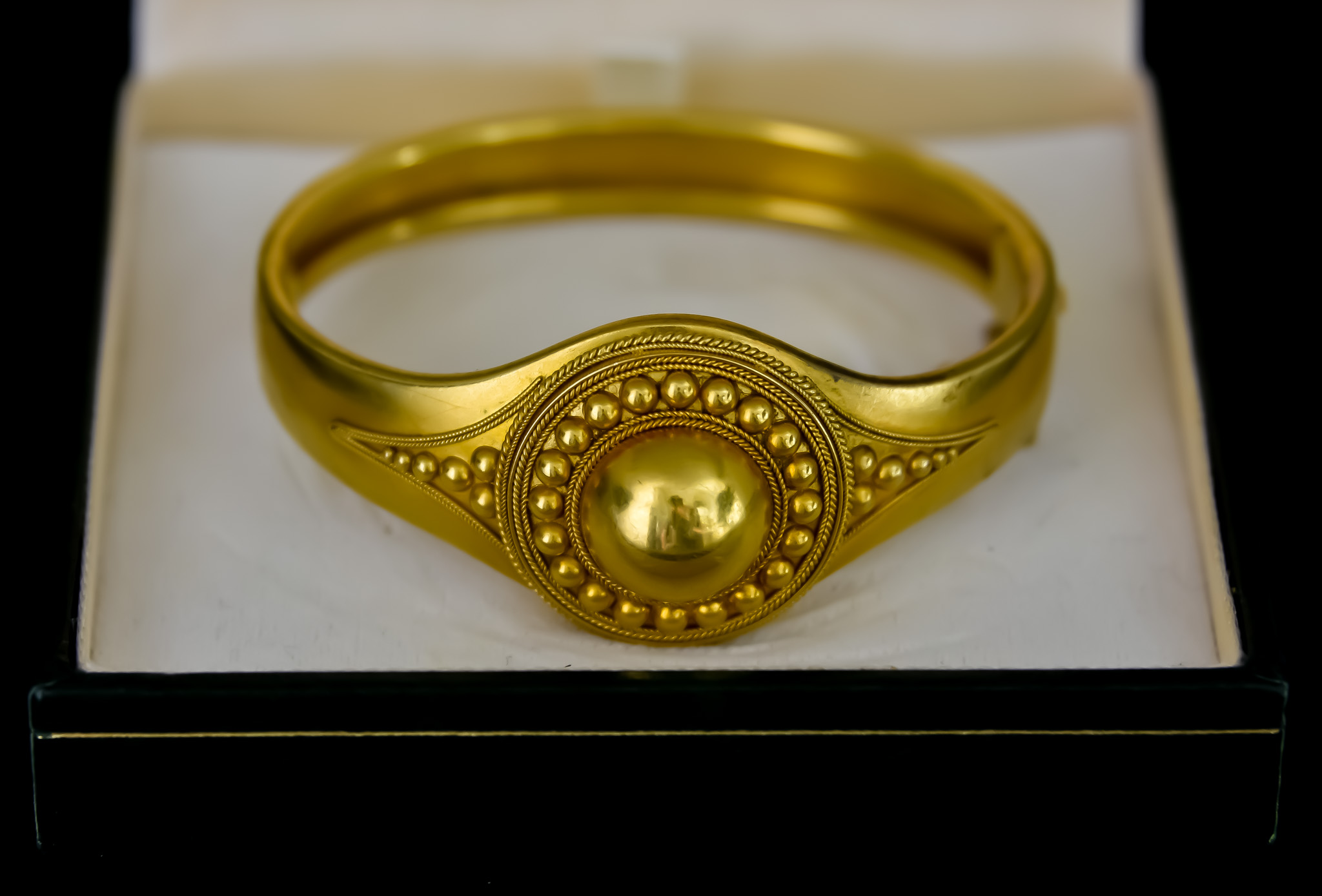 A Gold Metal Hinged Bangle, containing photograph in small locket compartment, gross weight 24g