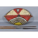 A Masai Shield, Kenya/Tanzania, 20th Century, of wood and cowhide construction, painted with organic