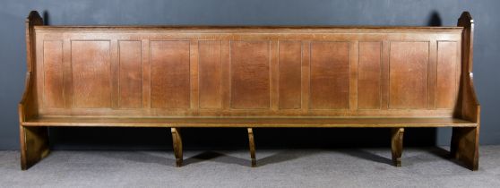 A Large Victorian Oak Pew, with heavy shaped and moulded end supports, panelled back and plain