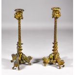 A Pair of Gilt Metal Candlesticks, Late 19th/Early 20th Century, the column supported by three