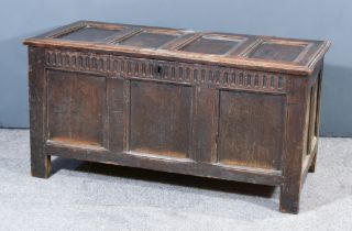 A Late 17th Century Panelled Oak Coffer with moulded edge and four fielded panels to top, carved and