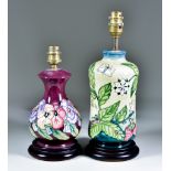 Two Moorcroft Pottery Table Lamps on Wooden Bases, one decorated with Fruit Garden design on a cream