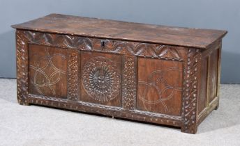 A 17th Century Panelled Oak Coffer, with moulded edge to top, the front panels carved with