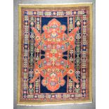 An Antique Salor Carpet, woven in colours of ivory, navy blue and terracotta, with a bold stylised
