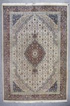 A 20th Century Bidjar Carpet, woven in muted shades with a central floral medallion on a wine
