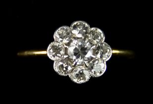 An 18ct Gold Flower Head Diamond Ring, set with brilliant cut white diamonds, approximately 1.